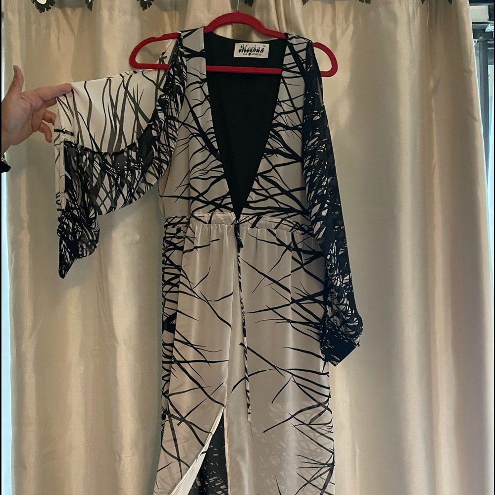 This long dress with a cut in the front. Long sleeve has never been worn.